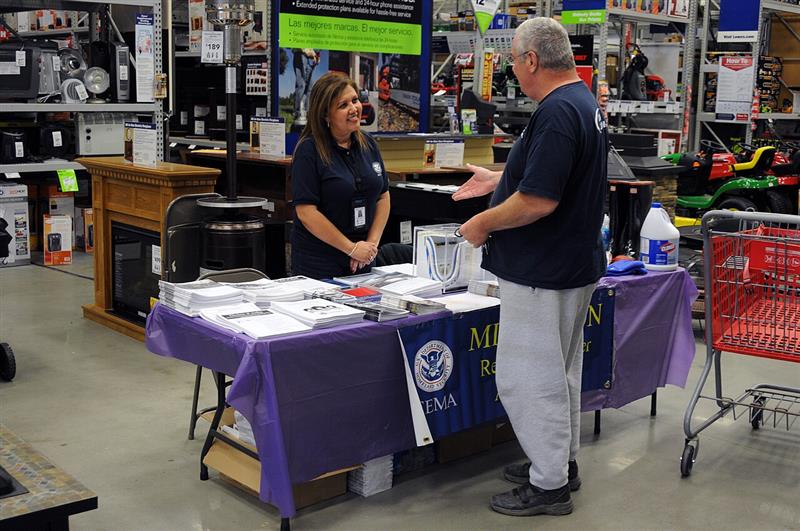 Disaster mitigation information table set up inside a retail store with brochures (FEMA photo by Andrea Booher)
